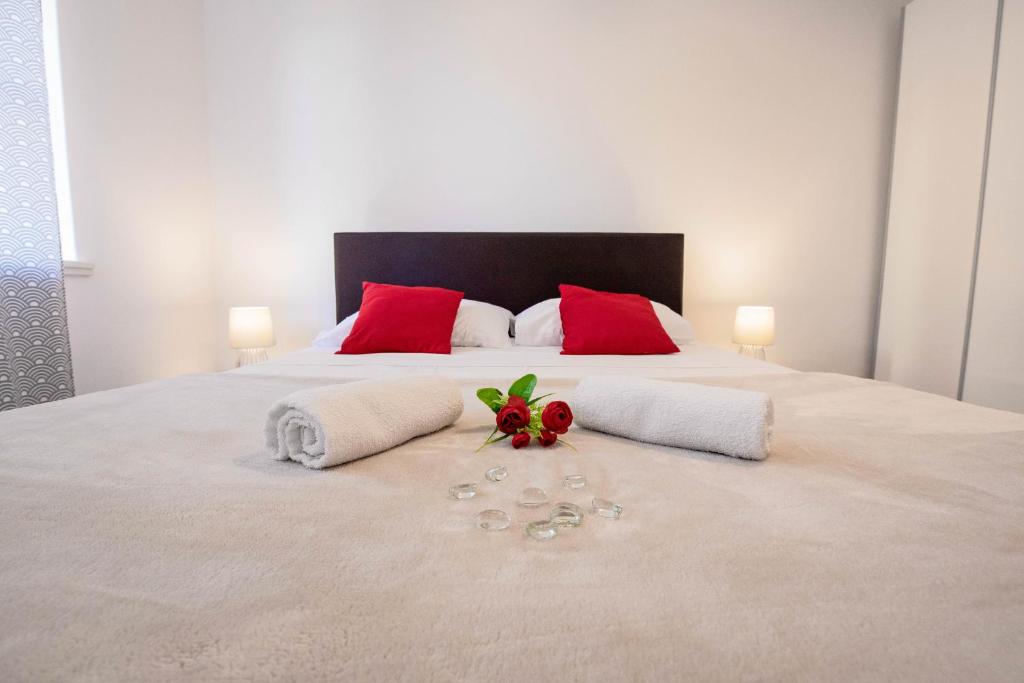 a bedroom with a large bed with red pillows at Ana Guesthouse in Dubrovnik