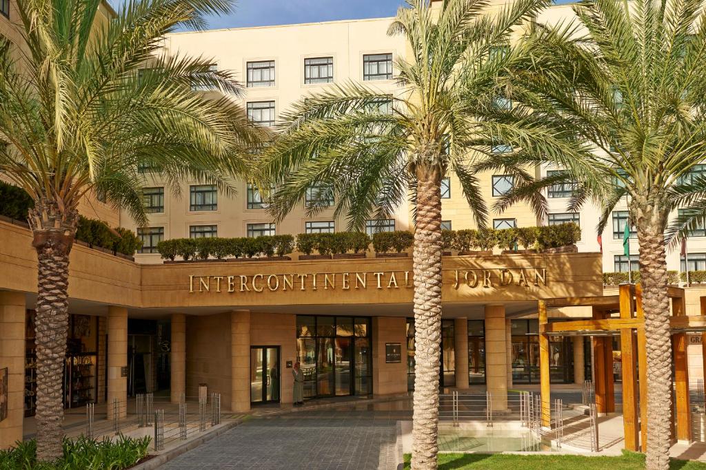 a building with palm trees in front of it at InterContinental Amman Jordan by IHG in Amman