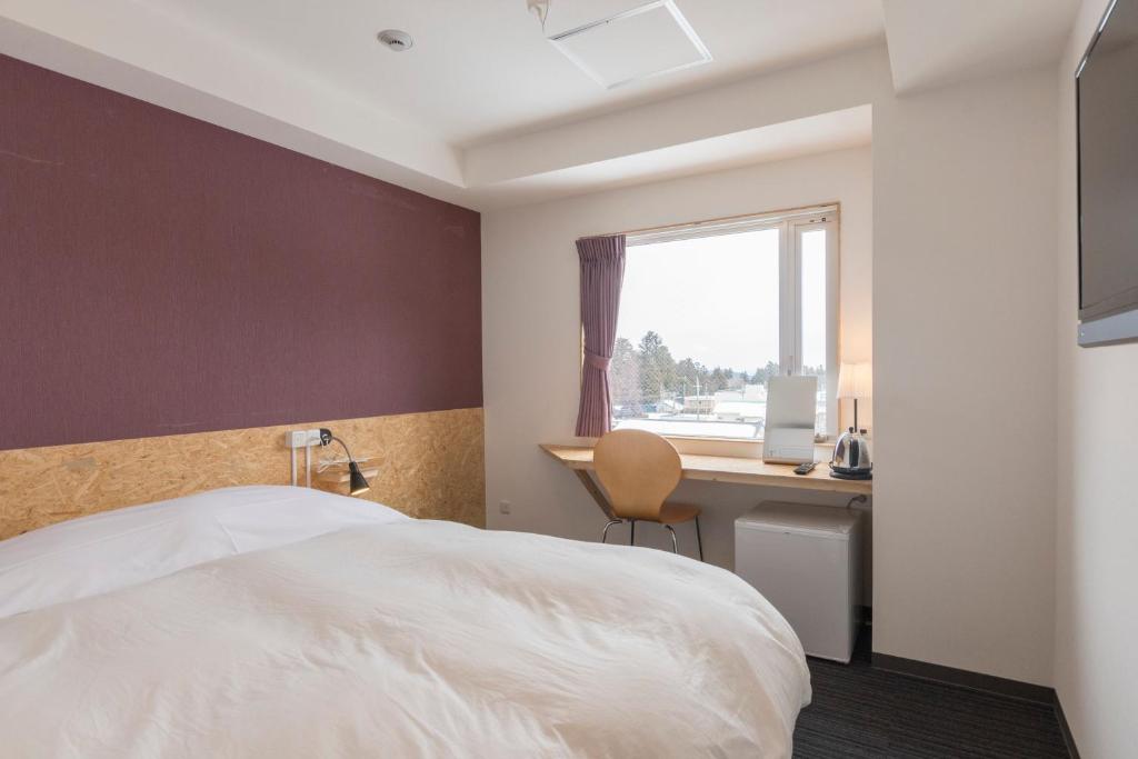 Postel nebo postele na pokoji v ubytování Nikko Station Hotel 2