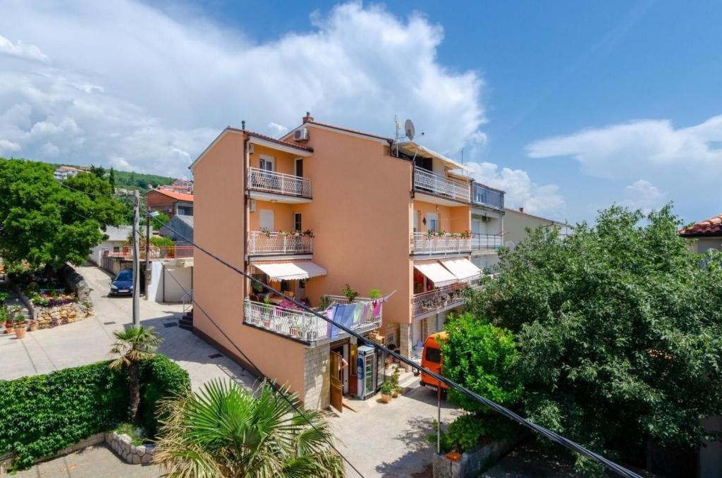 an apartment building with balconies and trees at Apartment in Crikvenica 27606 in Crikvenica