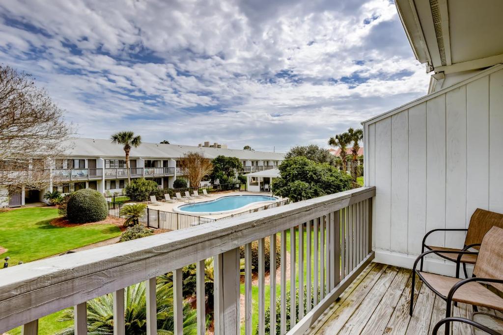 a balcony with a view of the pool and yard at Hidden Beach Villas 215 in Santa Rosa Beach