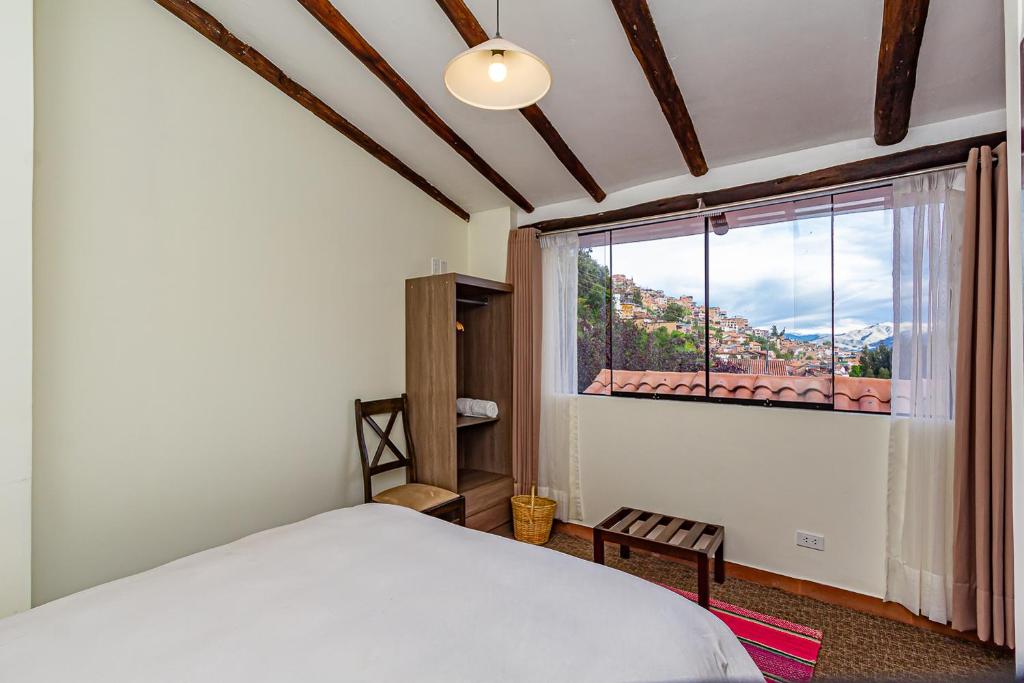 Postel nebo postele na pokoji v ubytování Luna House Cusco