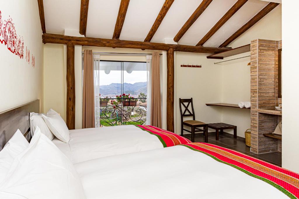 Postel nebo postele na pokoji v ubytování Luna House Cusco
