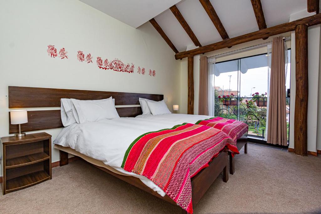 Postel nebo postele na pokoji v ubytování Luna House Cusco