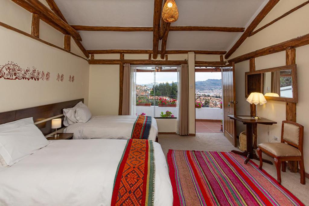 Postel nebo postele na pokoji v ubytování Luna House Cusco