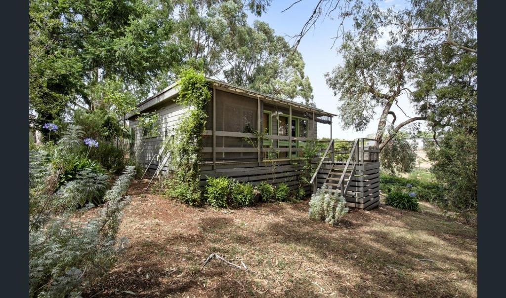 a house with vines growing on the side of it at Cozy Stay Cottage in Daylesford