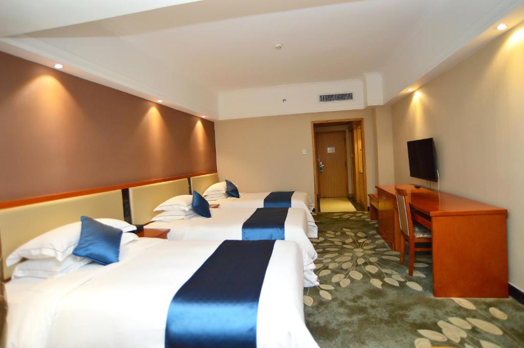 Postel nebo postele na pokoji v ubytování Shenzhen Kaili Hotel, Guomao Shopping Mall