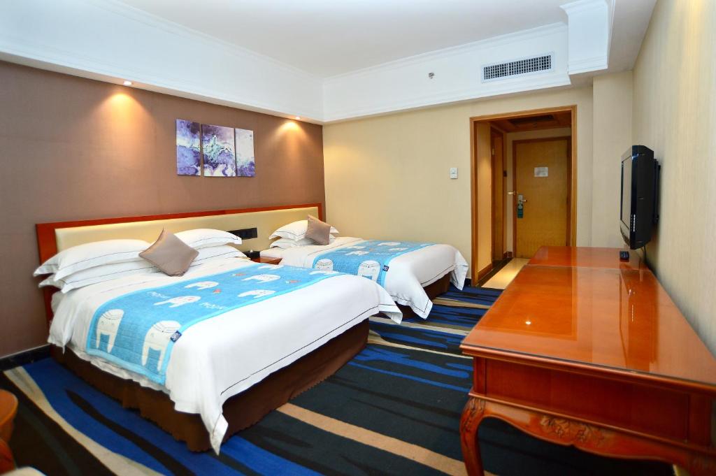 Postel nebo postele na pokoji v ubytování Shenzhen Kaili Hotel, Guomao Shopping Mall