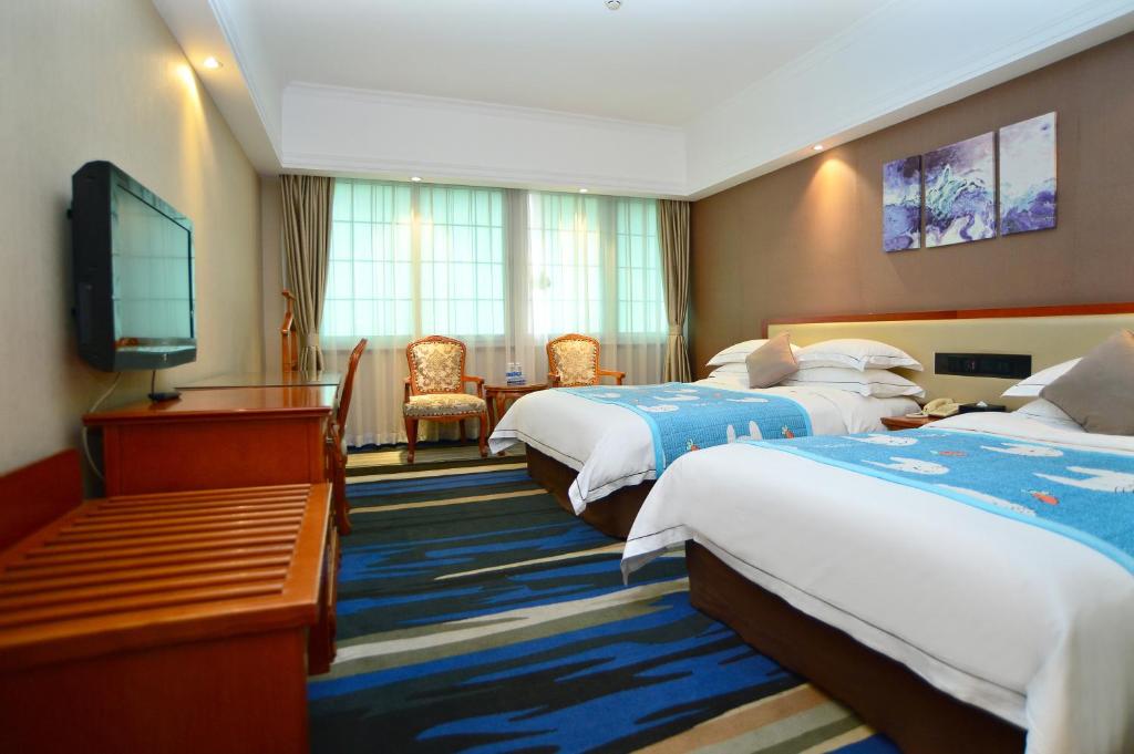 Postel nebo postele na pokoji v ubytování Shenzhen Kaili Hotel, Guomao Shopping Mall