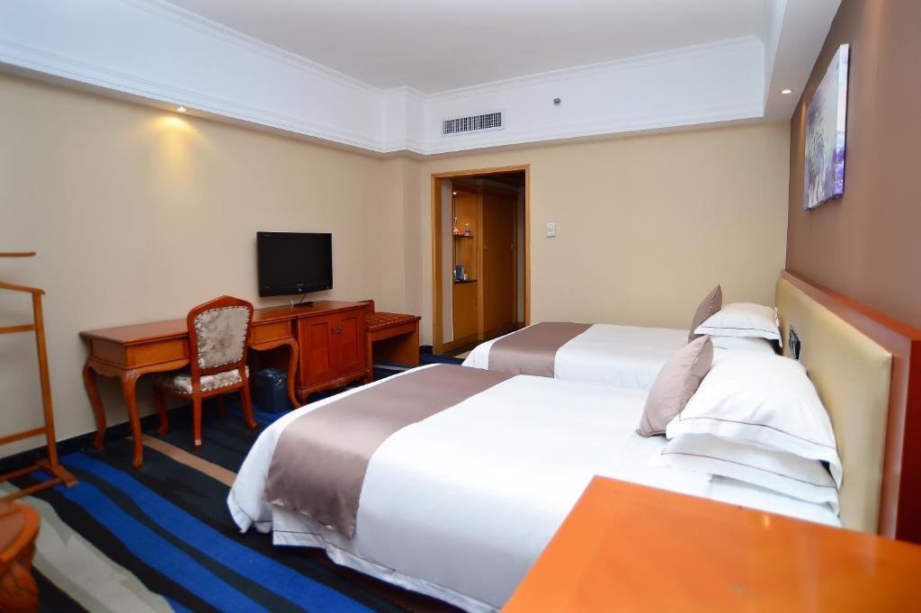 Postel nebo postele na pokoji v ubytování Shenzhen Kaili Hotel, Guomao Shopping Mall