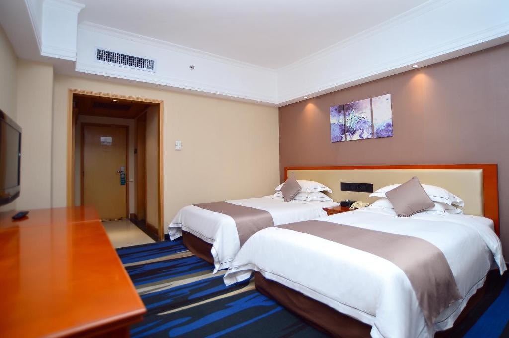 Postel nebo postele na pokoji v ubytování Shenzhen Kaili Hotel, Guomao Shopping Mall