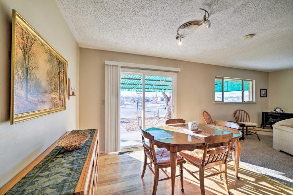 a dining room with a table and chairs and a living room at Cozy Cedar House - Family-Friendly Home with Yard! in Cortez