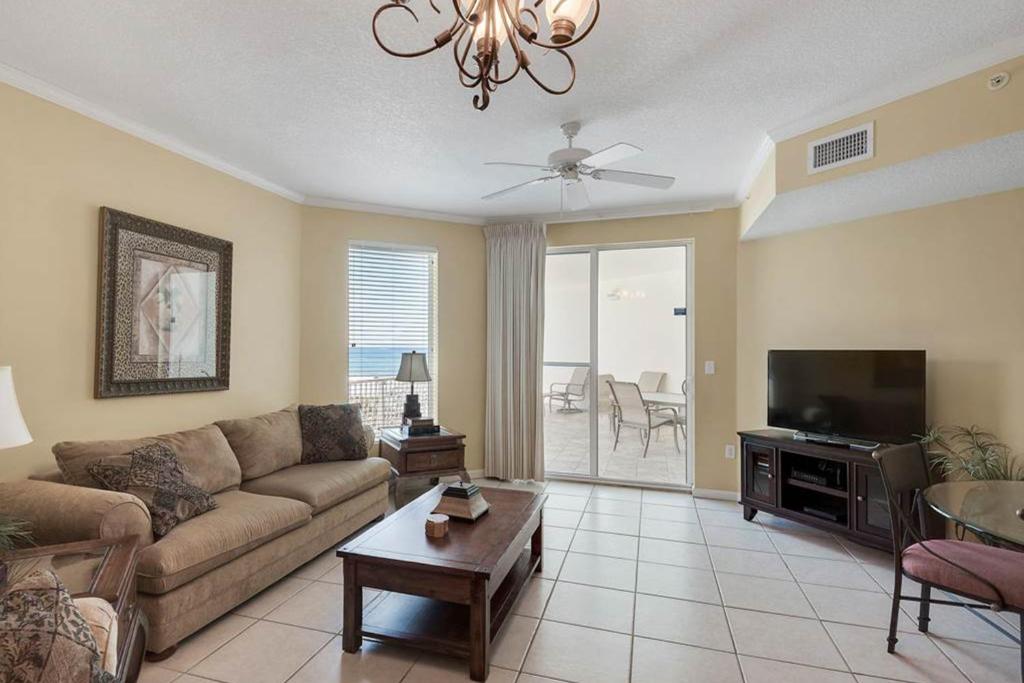 a living room with a couch and a flat screen tv at Dunes of Seagrove Condominiums in Seagrove Beach