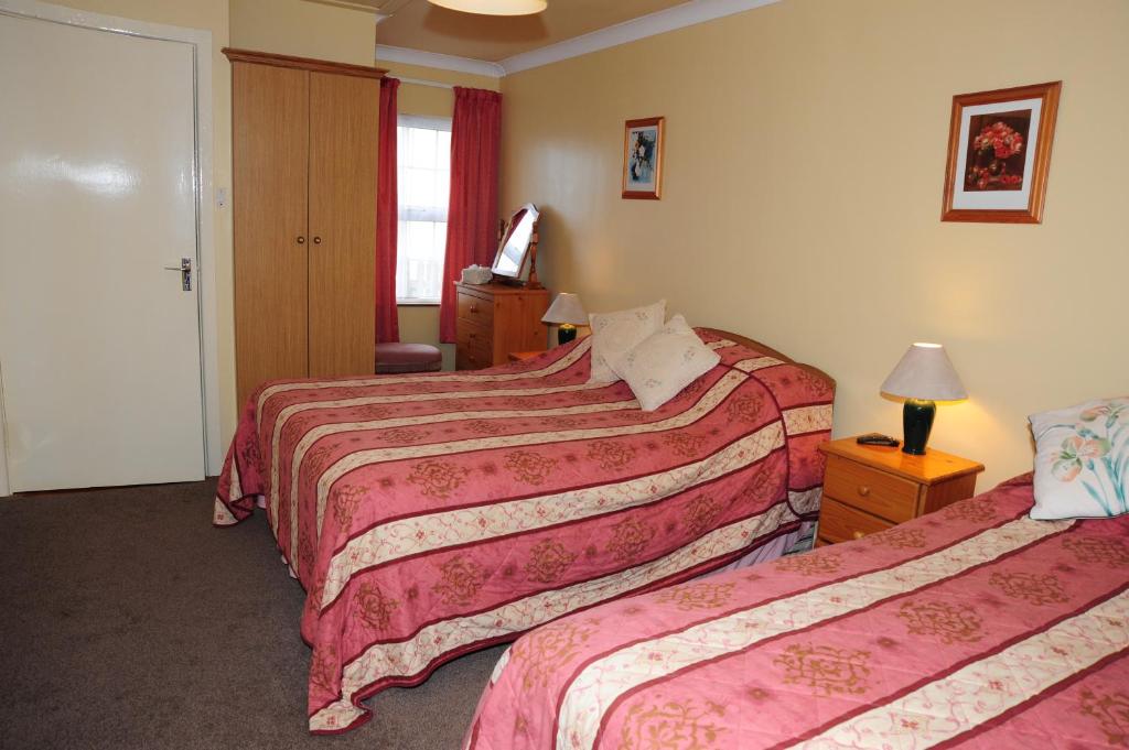 a hotel room with two beds and a window at The Mill Bar in Athlone