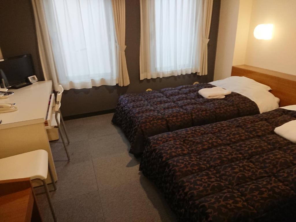 Postel nebo postele na pokoji v ubytování Residence Hotel Will Shinjuku
