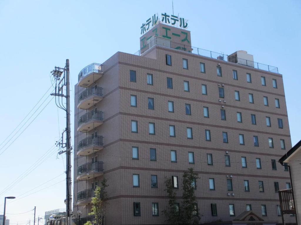 a building with a tower on top of it at Ace Inn Kariya in Kariya