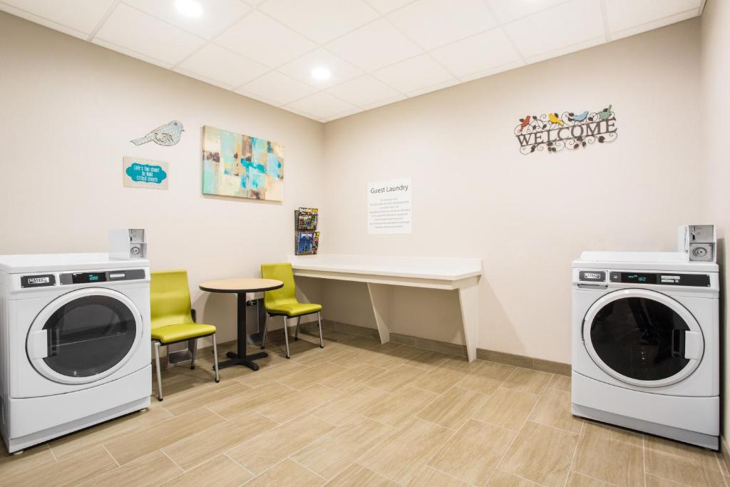 a laundry room with washing machines and a table at Holiday Inn Express & Suites - Rapid City - Rushmore South by IHG in Rapid City