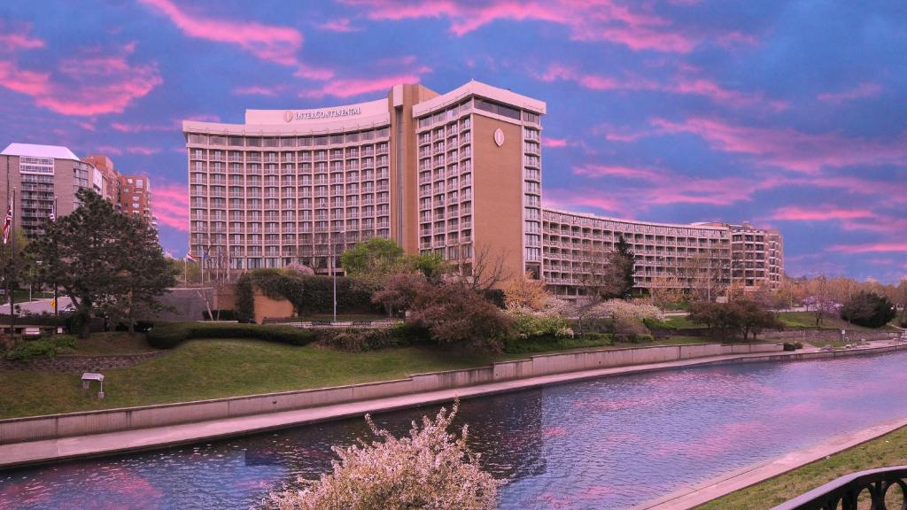 a large building with a river in front of it at InterContinental Kansas City at the Plaza by IHG in Kansas City