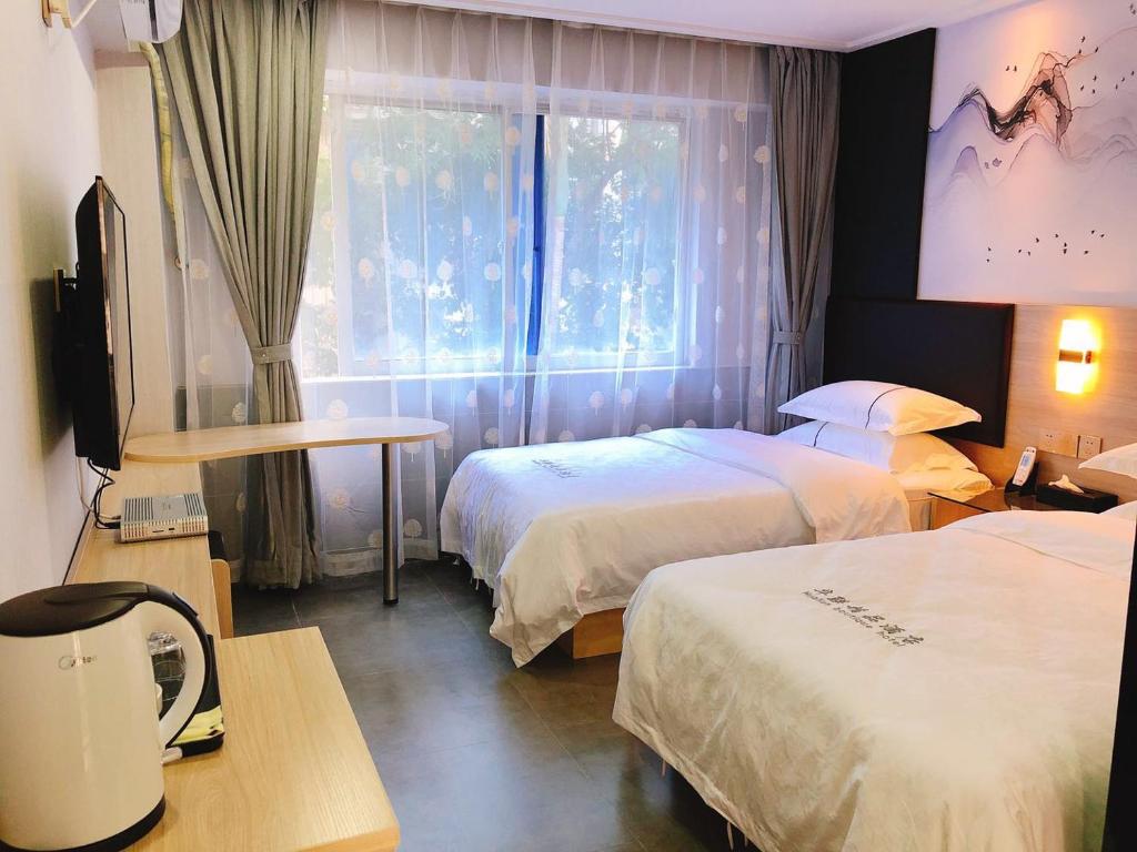 Postel nebo postele na pokoji v ubytování  Shenzhen Hualian Boutique Hotel
