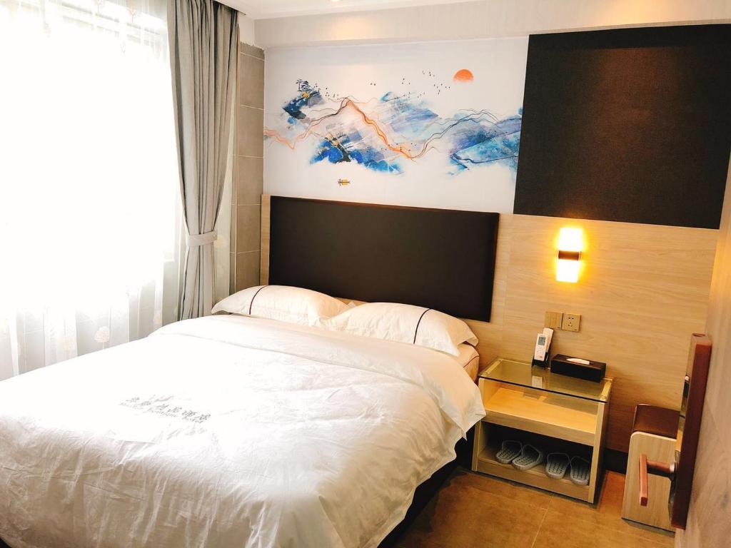 Postel nebo postele na pokoji v ubytování  Shenzhen Hualian Boutique Hotel