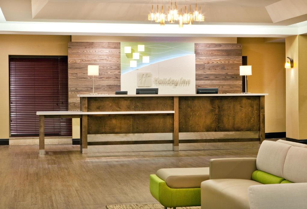 a lobby with a reception desk and a couch at Holiday Inn Little Rock - Presidential Downtown, an IHG Hotel in Little Rock