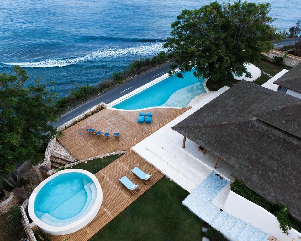 an overhead view of a swimming pool next to the ocean at Villa Victoria Nusa Penida in Nusa Penida