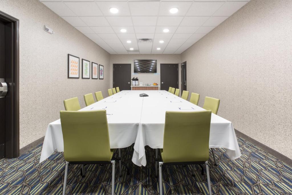 a conference room with a white table and chairs at Holiday Inn Express & Suites - Rapid City - Rushmore South by IHG in Rapid City