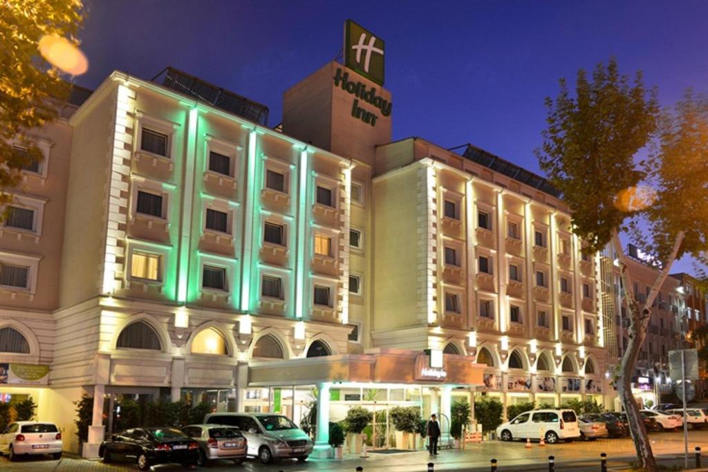 a large building with cars parked in front of it at Holiday Inn Istanbul City, an IHG Hotel in Istanbul