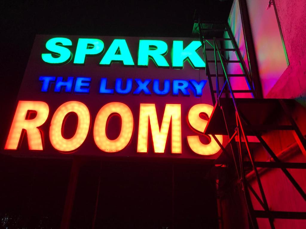 a neon sign that says spark the luxury rooms at HOTEL SPARK RESIDENCY in Chennai