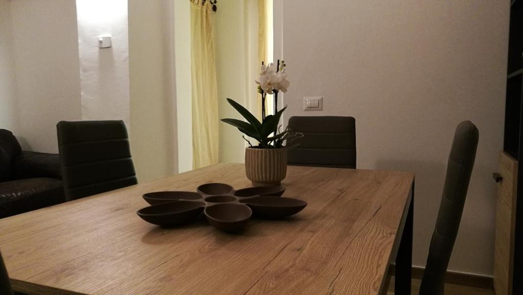 a dining room table with a vase with flowers on it at EApartmentsfoligno in Foligno