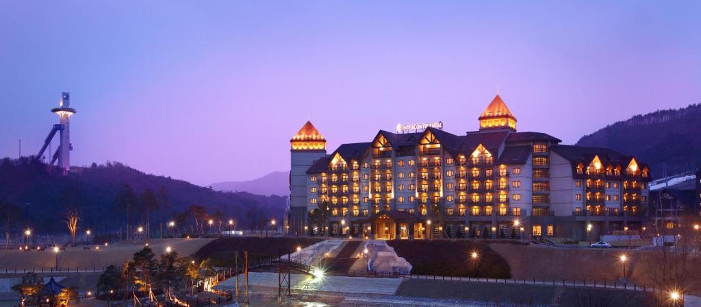 a large building with lights on top of it at night at Intercontinental Alpensia Pyeongchang Resort, an IHG Hotel in Pyeongchang