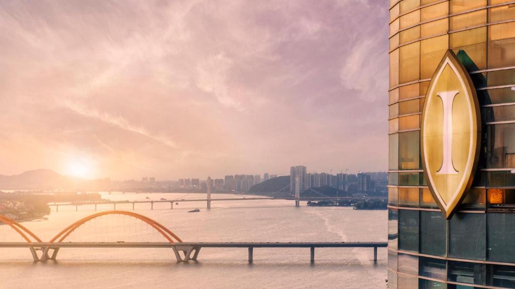 a bench on the side of a building next to a river at InterContinental Changsha, an IHG Hotel in Changsha