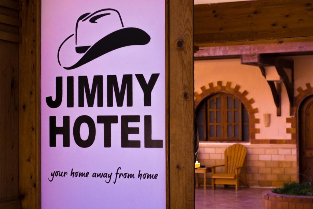 a sign for a jiminy hotel on the side of a building at Jimmy Hotel in Dahab