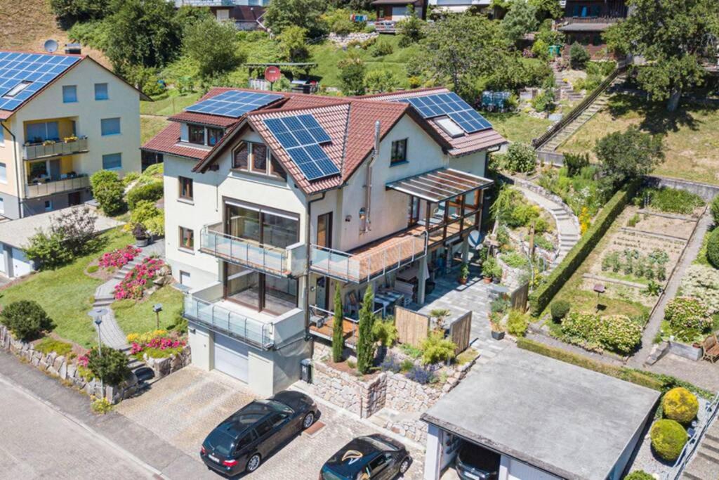 an aerial view of a house with solar panels on the roof at Ferienwohnung Habermehl in Oppenau