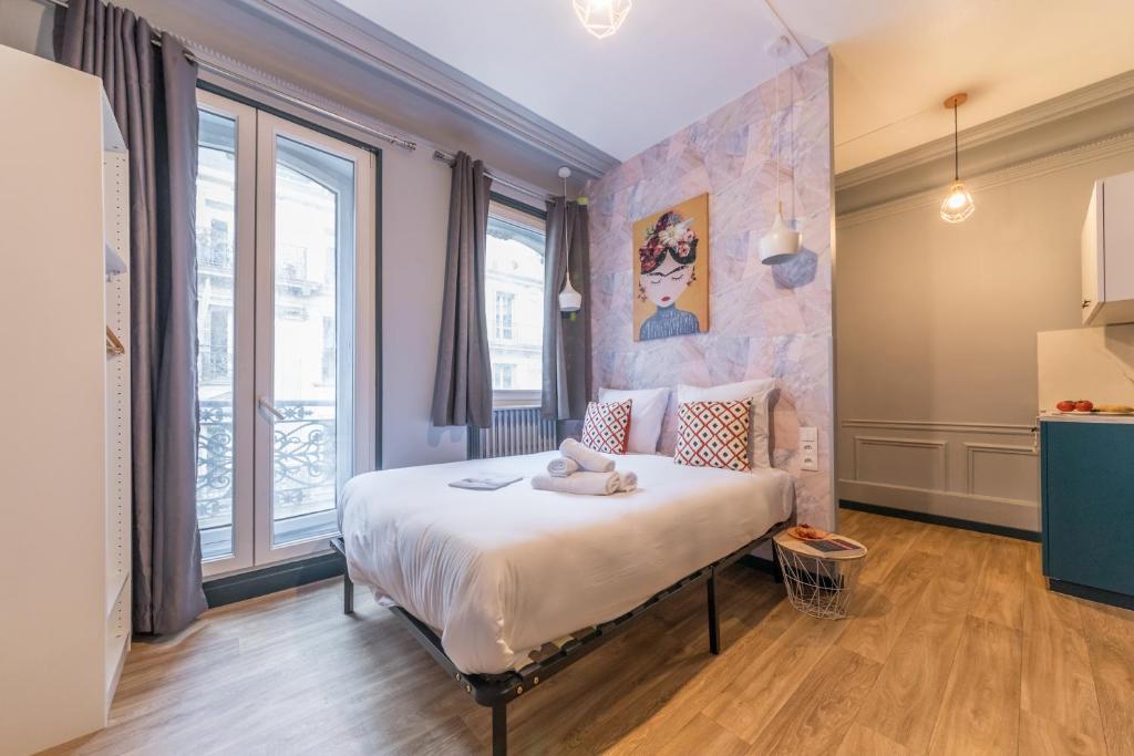 a bedroom with a bed with a stuffed animal on it at Apartments WS Grands Boulevards - Opera in Paris