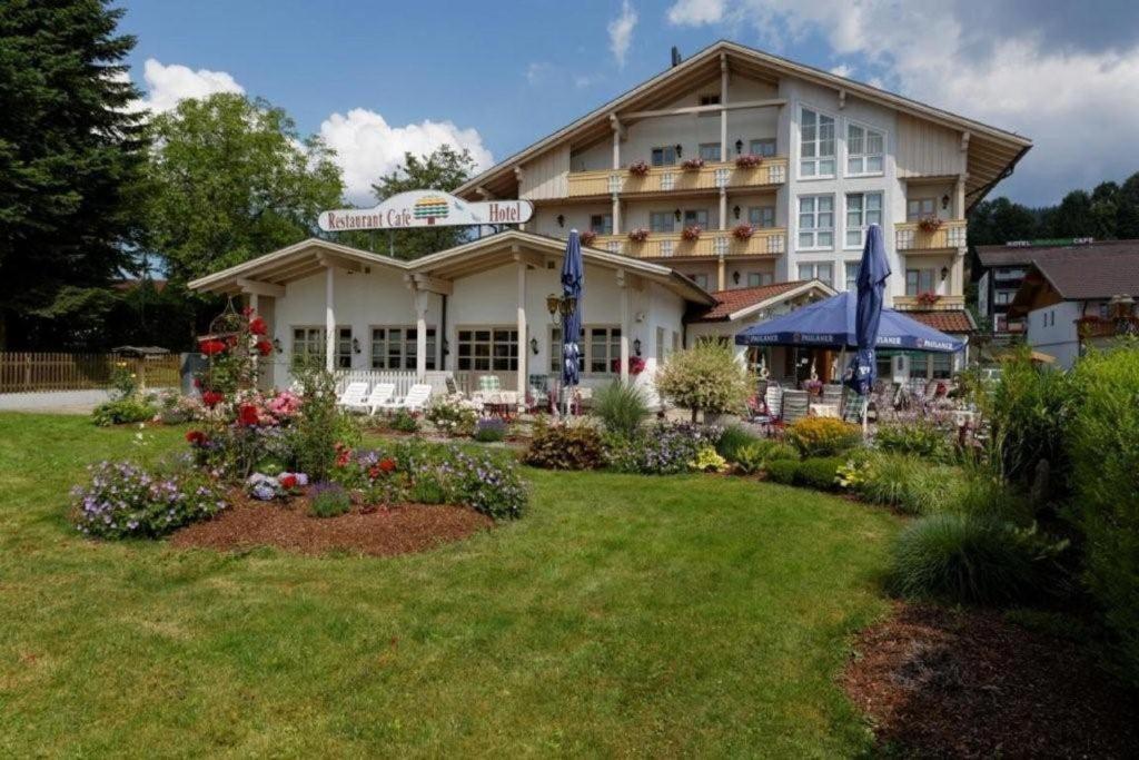 a large building with a garden in front of it at Hotel Kurpark in Bodenmais