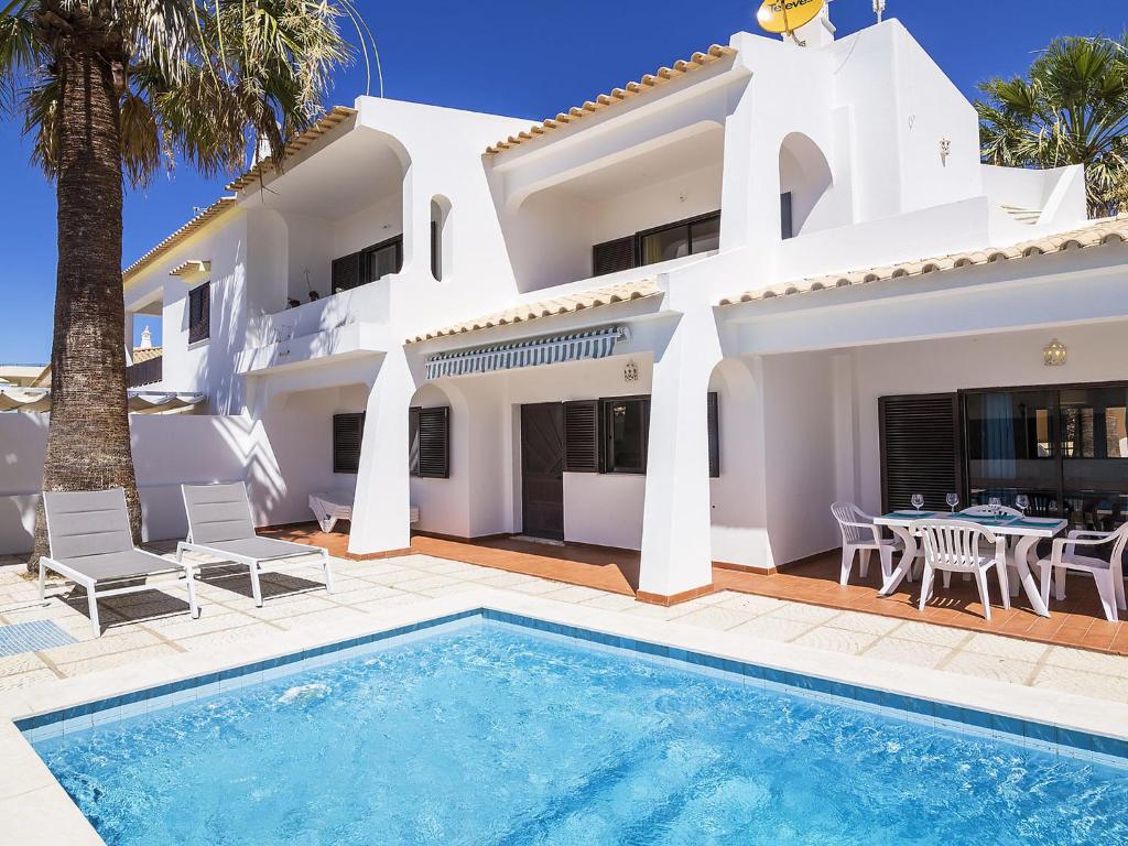 a villa with a swimming pool and a house at Villa Galé 600m from the beach by Interhome in Patroves