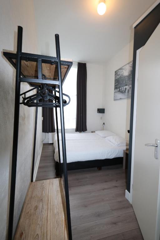 a bedroom with a bed and a window at Hotel Hortus in Amsterdam