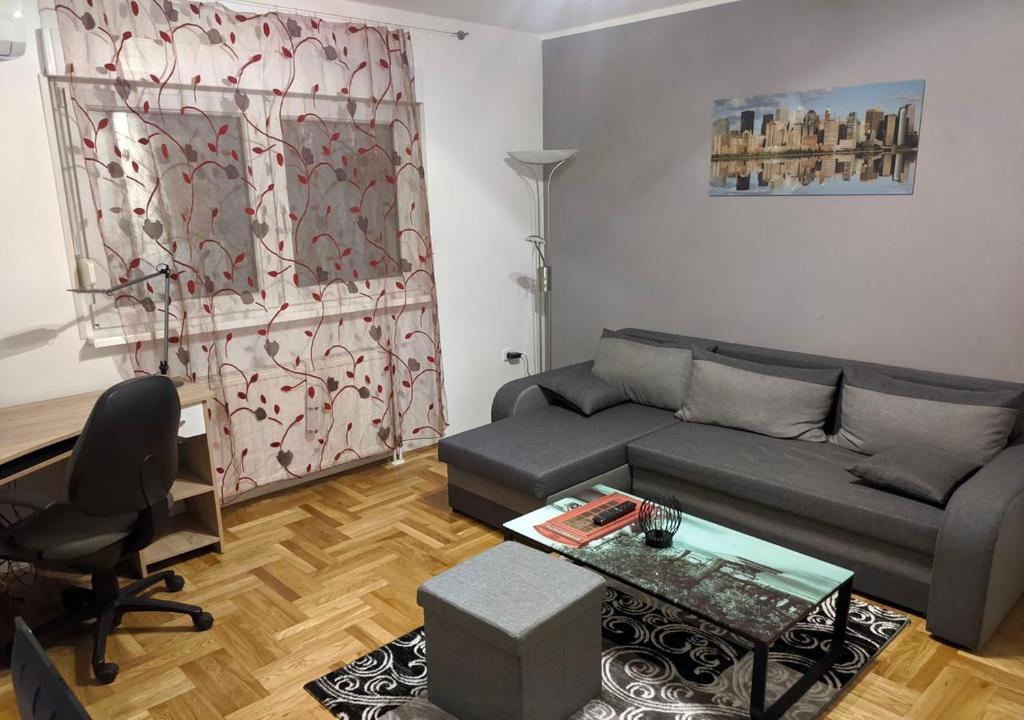 a living room with a couch and a table at Apartment in quiet area with free parking in Varaždin