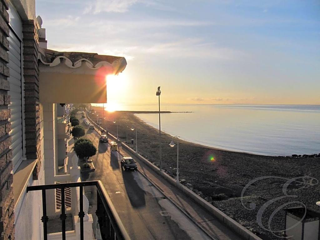 a view of the ocean from a balcony of a building at First line beach apartment in Algarrobo