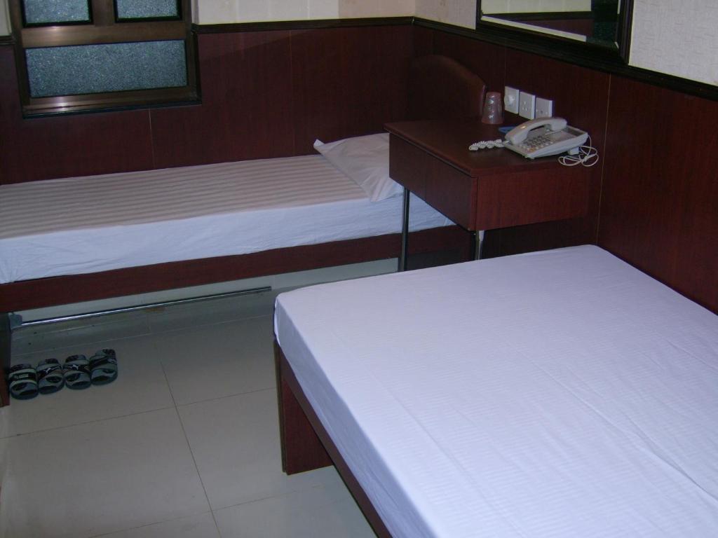 Postel nebo postele na pokoji v ubytování Hong Kong CoLiving Space
