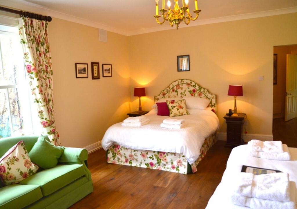 a hotel room with a bed and a couch at Delphi Lodge in Leenaun