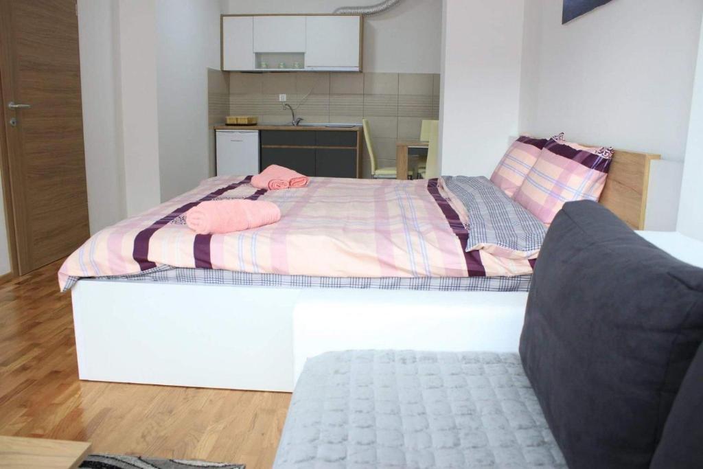 a bedroom with a large bed with pink sheets at Apartments S*A in Ohrid