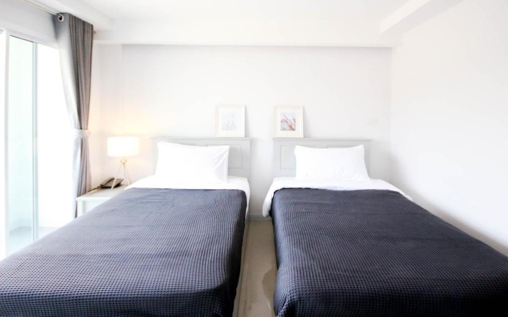 Postel nebo postele na pokoji v ubytování Tonkla Boutique Hotel