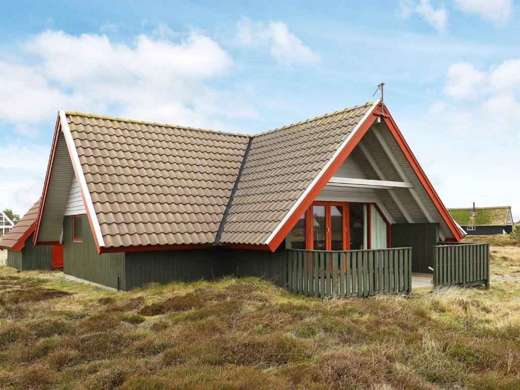 a small house on top of a hill at 6 person holiday home in Hvide Sande in Bjerregård