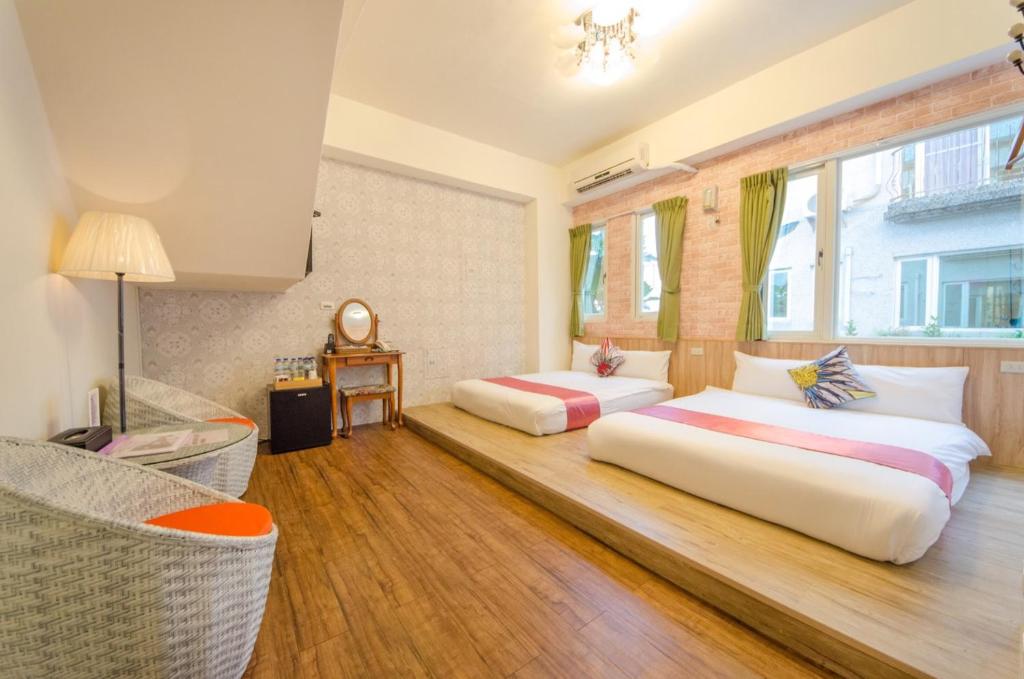 Postel nebo postele na pokoji v ubytování Sweet B&B 幸福微甜民宿