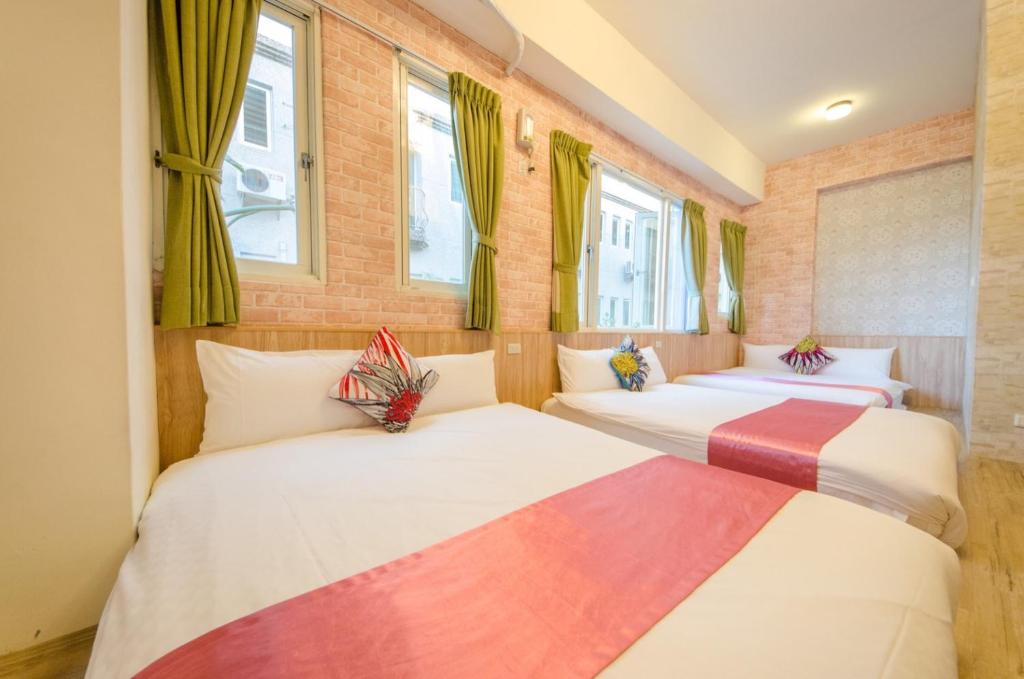 Postel nebo postele na pokoji v ubytování Sweet B&B 幸福微甜民宿