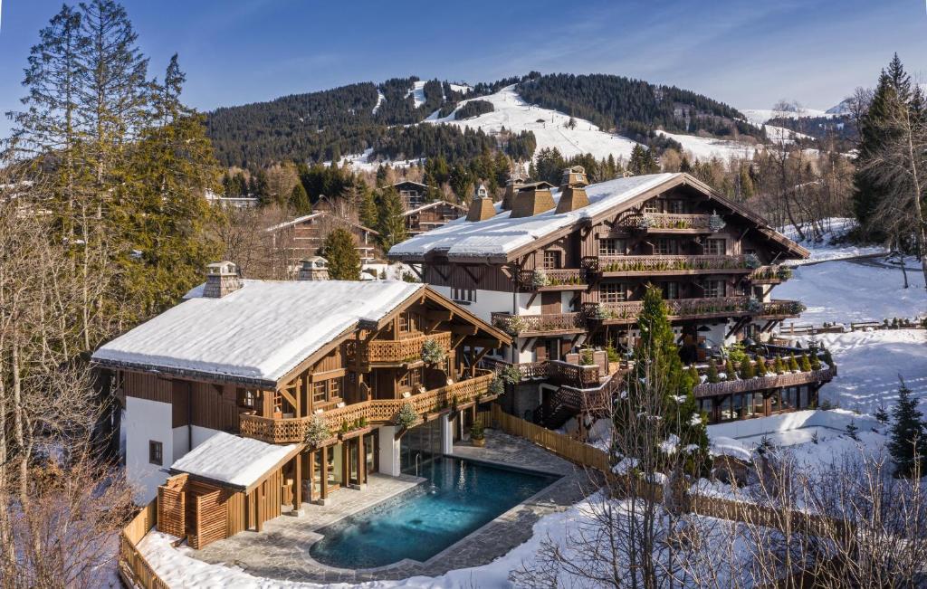 an aerial view of a house with a pool in the snow at Les Chalets du Mont d'Arbois & Spa, Megève in Megève