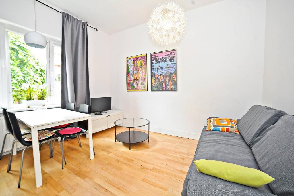 a living room with a couch and a table at White Sand Apartment Centrum by Grand Apartments in Sopot