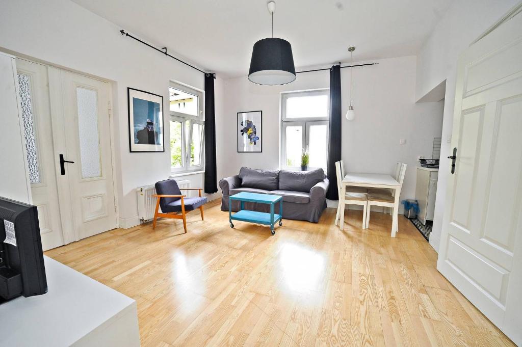 a living room with a couch and a table at White Rock Apartment by Grand Apartments in Sopot